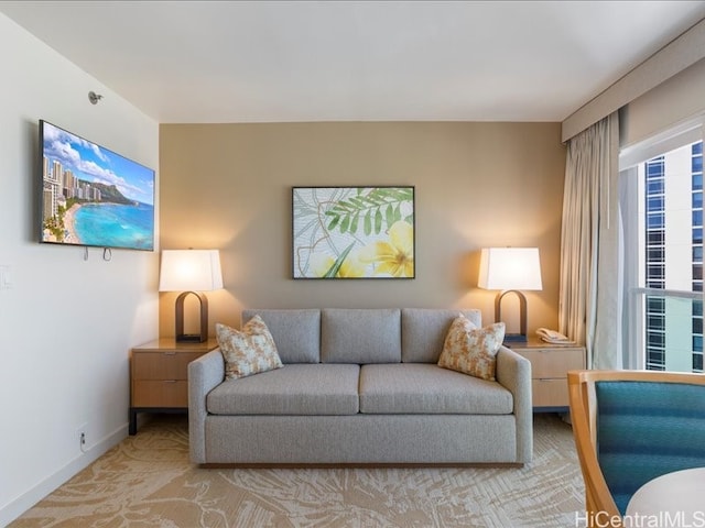 living room featuring baseboards and light colored carpet