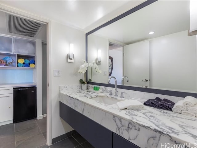 bathroom with vanity, visible vents, and tile patterned floors