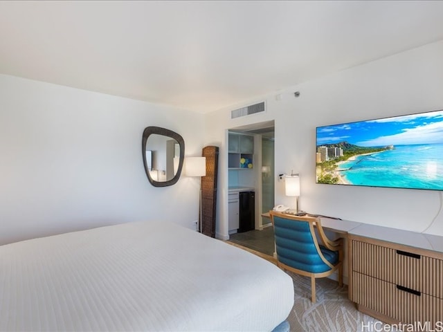 bedroom with visible vents and built in desk