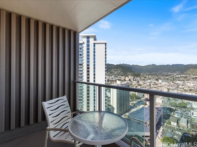 balcony with a view of city and a mountain view