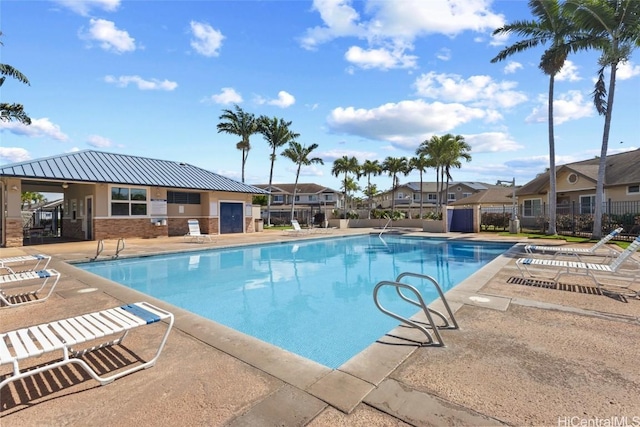 pool featuring a residential view, fence, and a patio