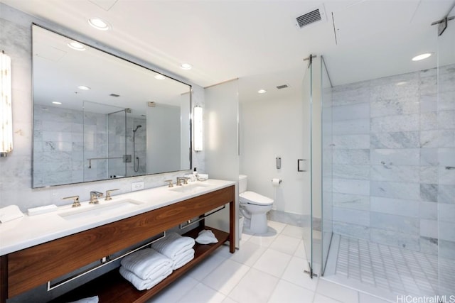 full bathroom featuring double vanity, visible vents, toilet, a shower stall, and a sink