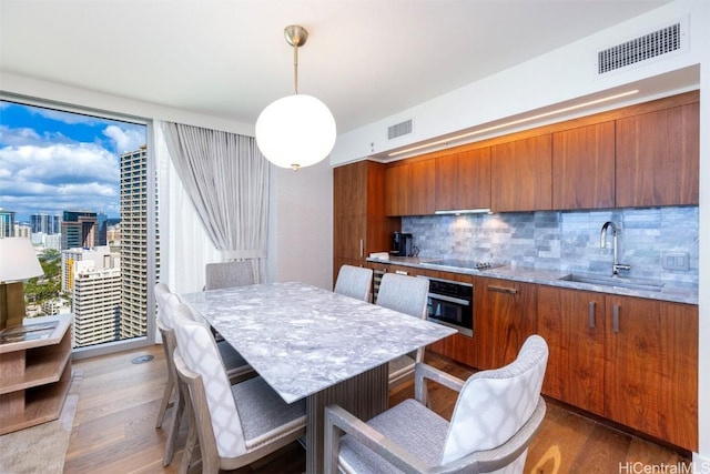 dining room with visible vents and wood finished floors