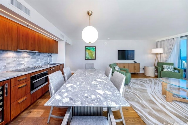 dining area featuring wood finished floors and visible vents