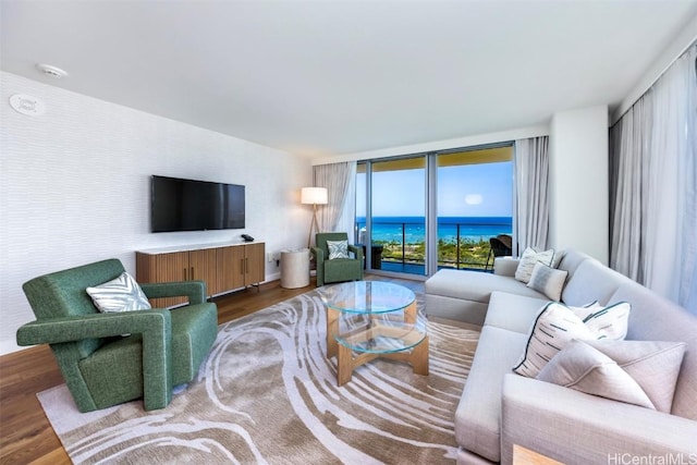 living area with expansive windows and wood finished floors