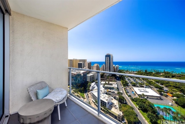 balcony featuring a view of city and a water view