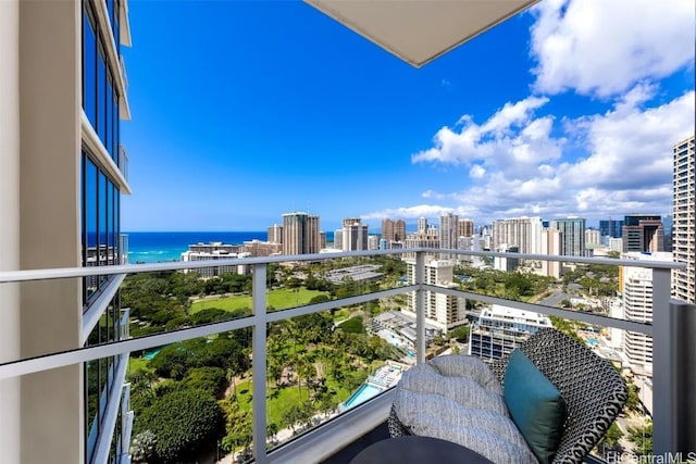 balcony featuring a water view and a city view