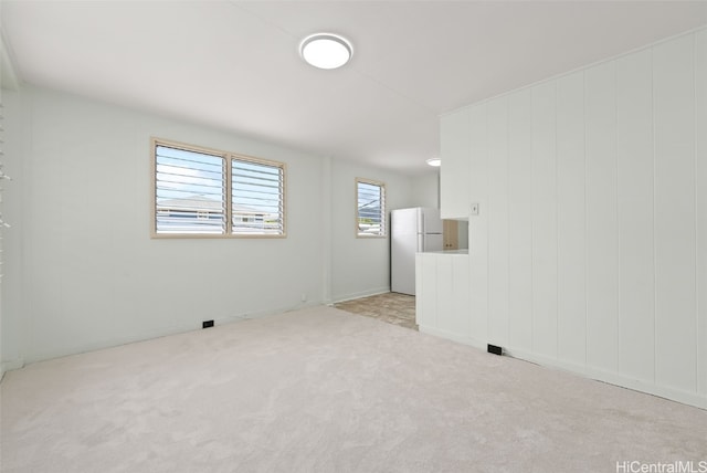 unfurnished room with light carpet