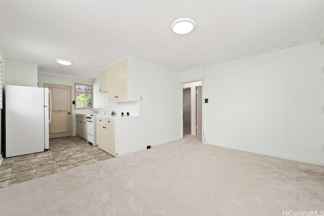 kitchen with dishwasher, light colored carpet, light countertops, and freestanding refrigerator