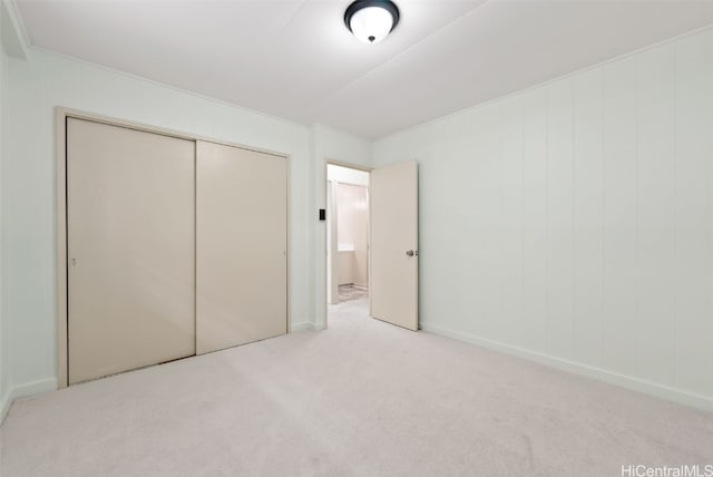 unfurnished bedroom featuring a closet and carpet