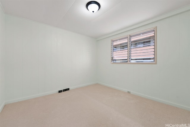 carpeted spare room featuring baseboards