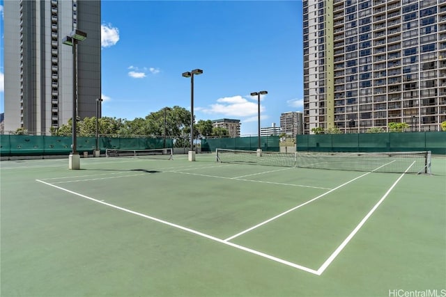 view of tennis court featuring fence