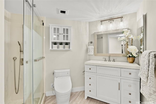 full bath featuring vanity, a shower stall, and toilet