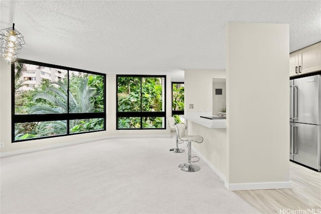 interior space with baseboards and a textured ceiling