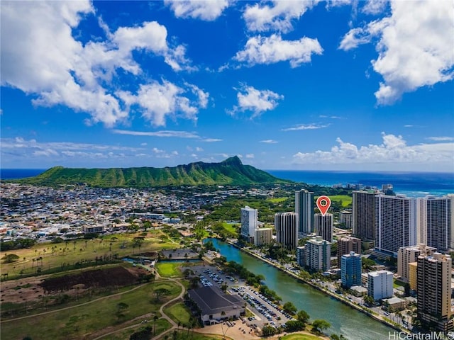 birds eye view of property with a water view and a city view