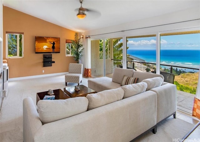 living room featuring lofted ceiling, baseboards, and carpet floors