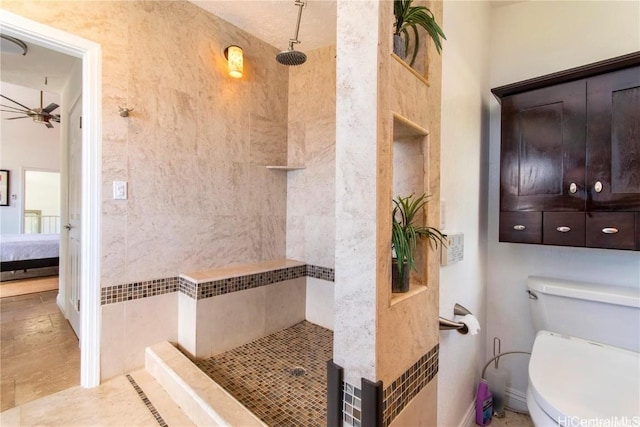 ensuite bathroom featuring ensuite bathroom, tiled shower, toilet, and a ceiling fan