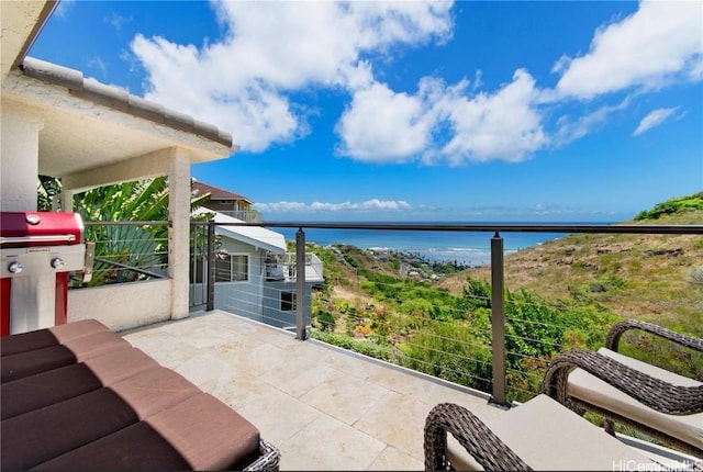 view of patio with a water view, a balcony, and a grill