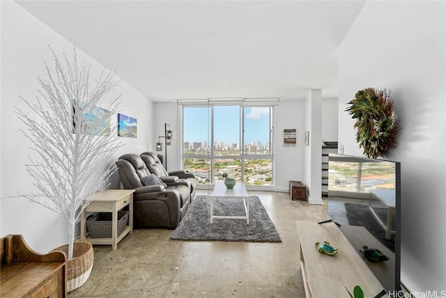 living room with concrete floors and a wall of windows