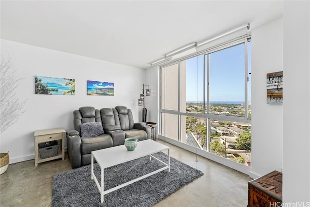 living room featuring concrete floors and a wall of windows