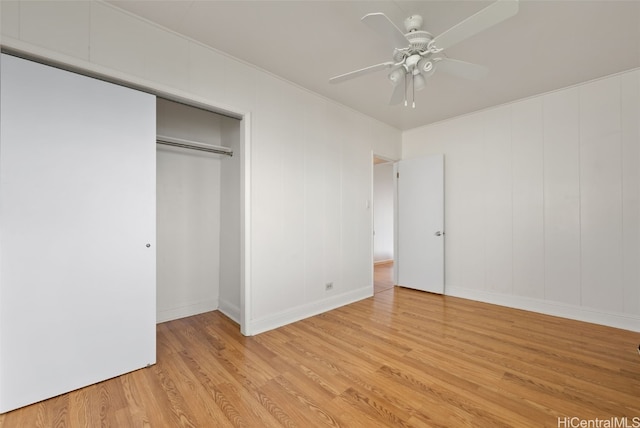 unfurnished bedroom with a closet, wood finished floors, and a ceiling fan