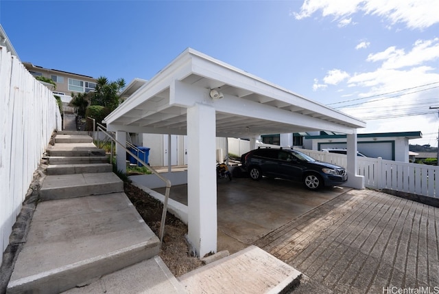 view of parking / parking lot featuring fence