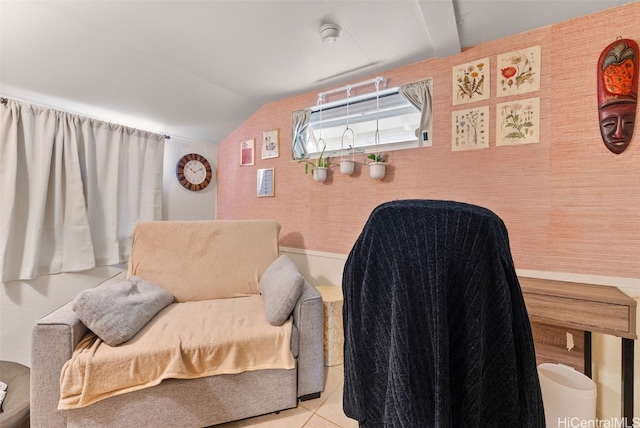 living area with lofted ceiling and tile patterned flooring