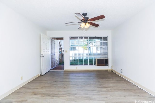 unfurnished room featuring ceiling fan, a textured ceiling, and wood finished floors