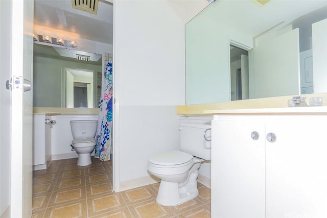 full bath featuring toilet, visible vents, and vanity