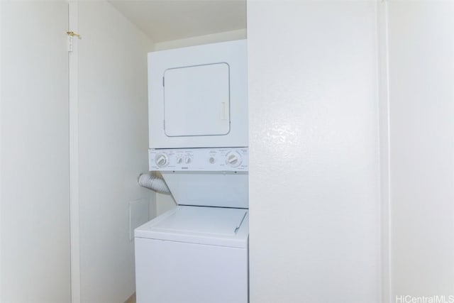 clothes washing area with laundry area and stacked washer and clothes dryer