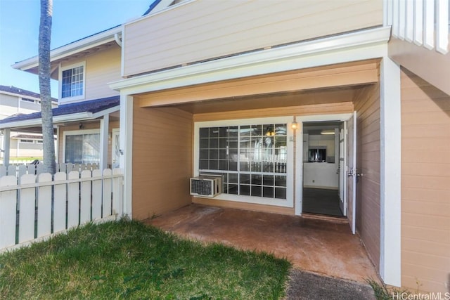 doorway to property featuring fence