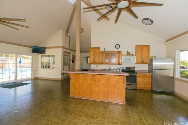 kitchen featuring ceiling fan, stainless steel appliances, brown cabinetry, and glass insert cabinets