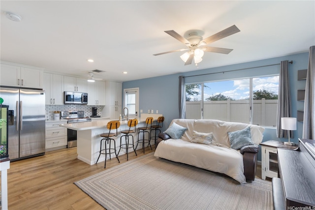 91-418 Makalea St Unit 92, Ewa Beach, HI 96706 - living room with light wood-type flooring, recessed lighting, ceiling fan, and visible vents