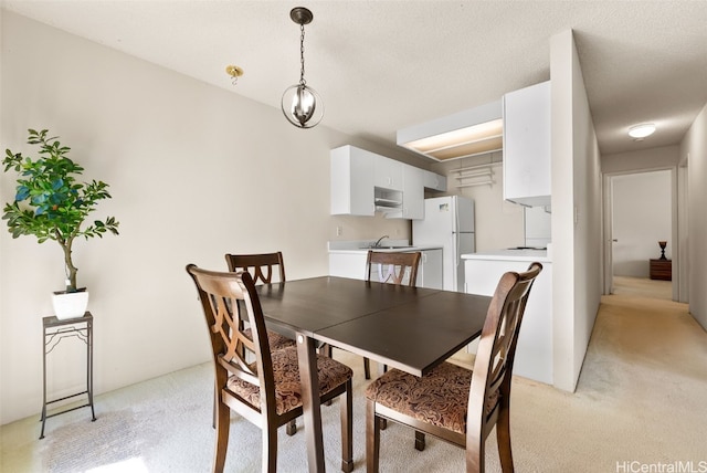 dining space featuring light colored carpet