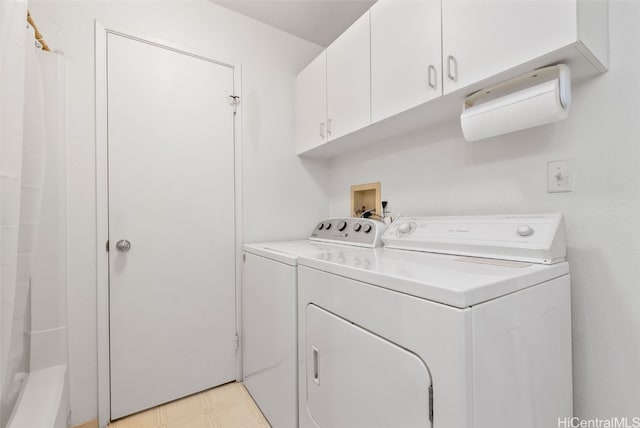 washroom with washer and dryer, cabinet space, and light floors