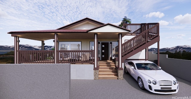 view of front of house with a mountain view and stairway