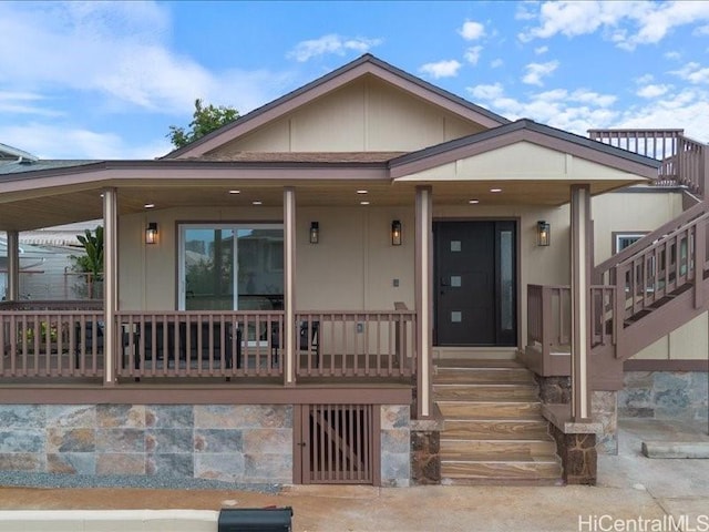 view of front of house with covered porch and stairs