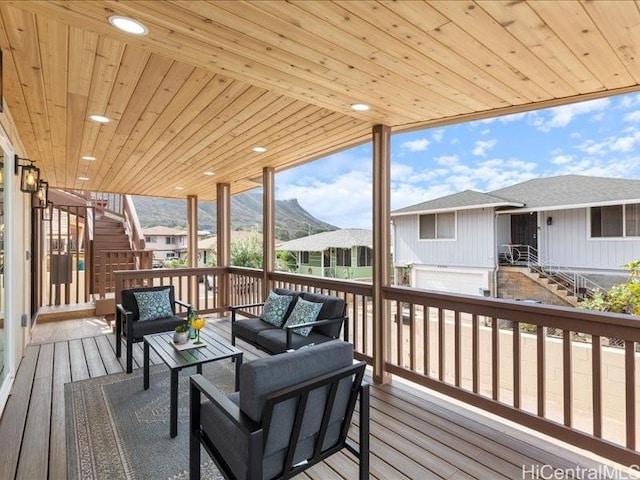 wooden terrace featuring stairway, a residential view, and outdoor lounge area