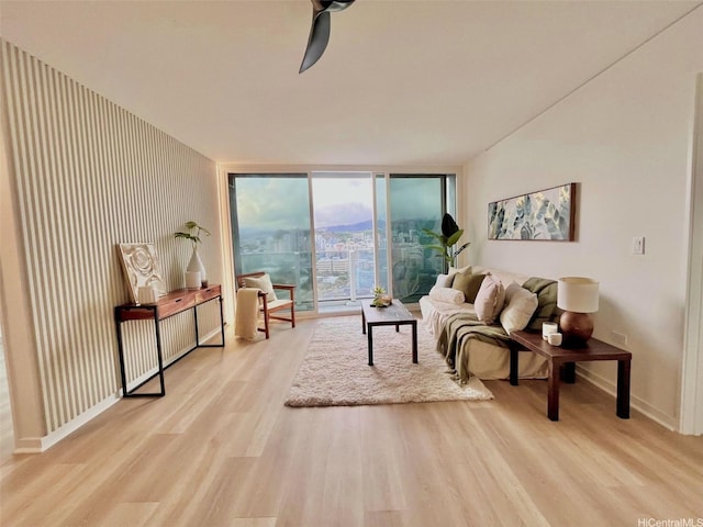 1296 Kapiolani Blvd Unit Ii-2509E, Honolulu, HI 96814 - living area with wood finished floors, baseboards, expansive windows, and ceiling fan