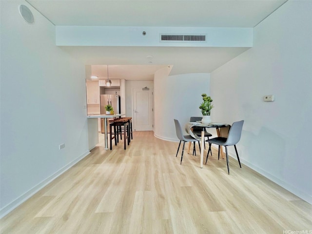 1296 Kapiolani Blvd Unit Ii-2509E, Honolulu, HI 96814 - dining space featuring light wood finished floors and baseboards