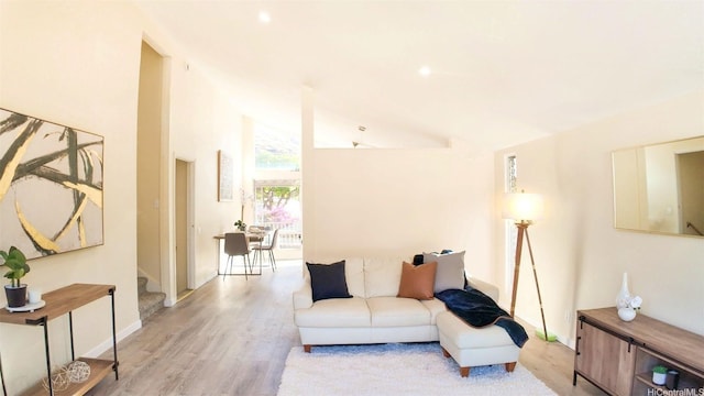 1296 Kapiolani Blvd Unit Ii-2509E, Honolulu, HI 96814 - living area featuring light wood-type flooring, stairs, and lofted ceiling