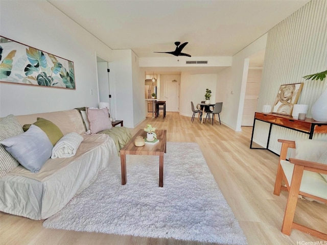 1296 Kapiolani Blvd Unit Ii-2509E, Honolulu, HI 96814 - living room featuring wood finished floors, ceiling fan, and baseboards