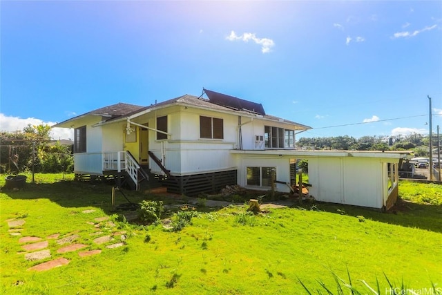 back of house featuring a lawn