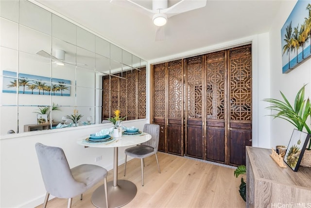 dining room featuring a ceiling fan and wood finished floors