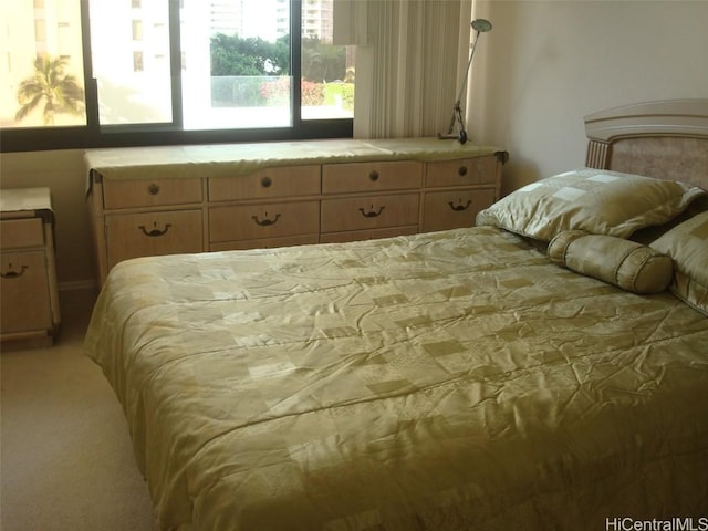 bedroom featuring light carpet