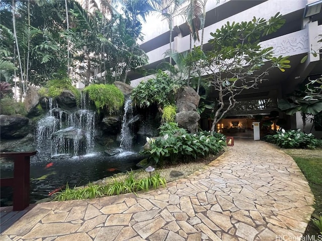 view of home's community with a garden pond