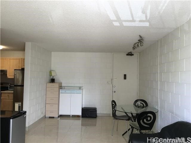 2714 Kahoaloha Ln Unit 503, Honolulu, HI 96826 - kitchen with freestanding refrigerator, refrigerator, and concrete block wall
