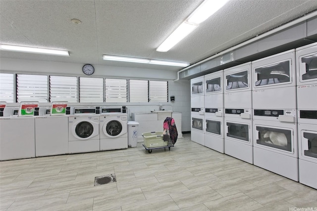 2714 Kahoaloha Ln Unit 503, Honolulu, HI 96826 - community laundry room featuring stacked washer / drying machine, washing machine and clothes dryer, and a textured ceiling