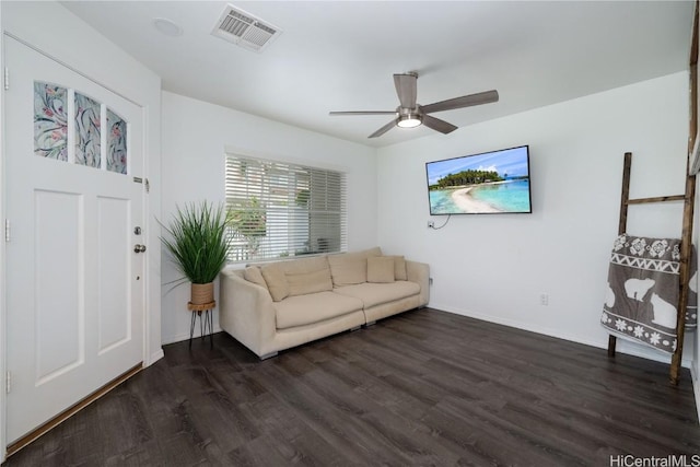 living area with a ceiling fan, visible vents, dark wood finished floors, and baseboards