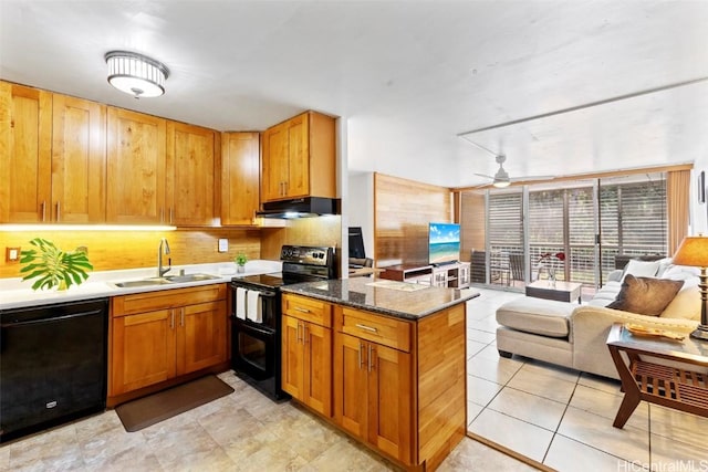 kitchen featuring open floor plan, a peninsula, under cabinet range hood, black appliances, and a sink